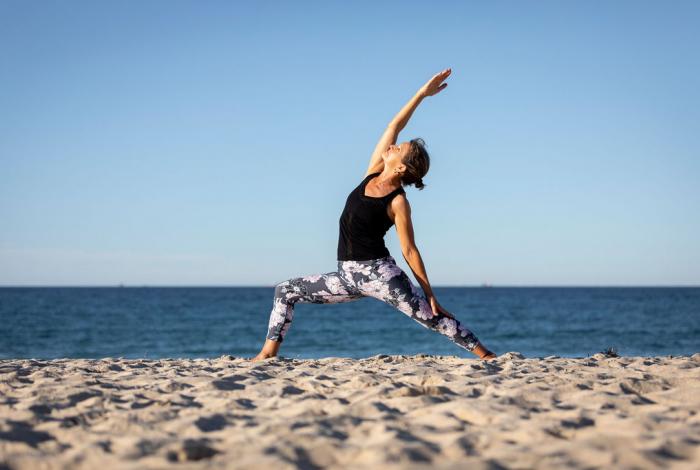Photo of senior doing Yoga on the beach