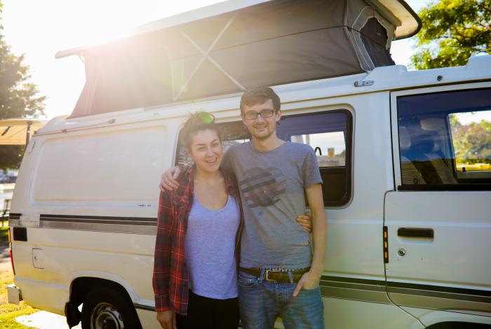 Photo of couple in front of camper van