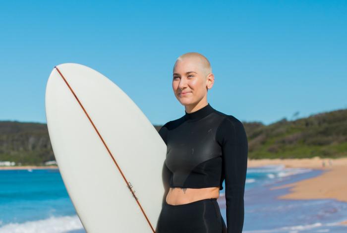 Woman holding a surfboard on beach