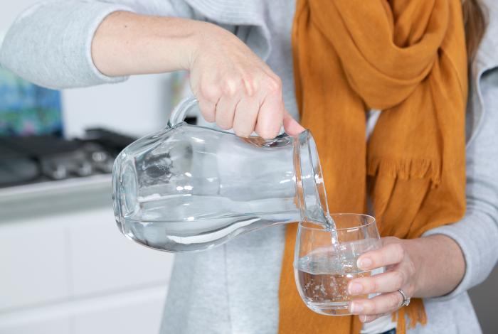 woman pouring a glass of water
