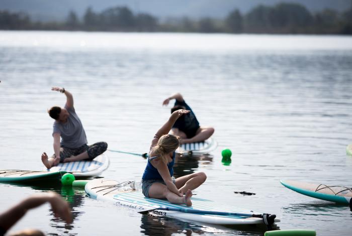 Photo of Yoga being conducted on stand up paddle board 