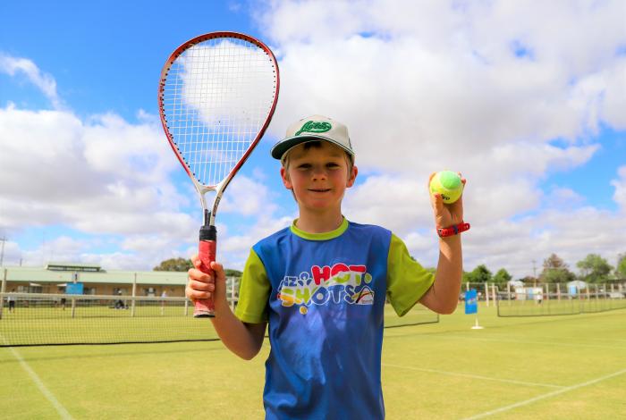 Boy holding tennis racket